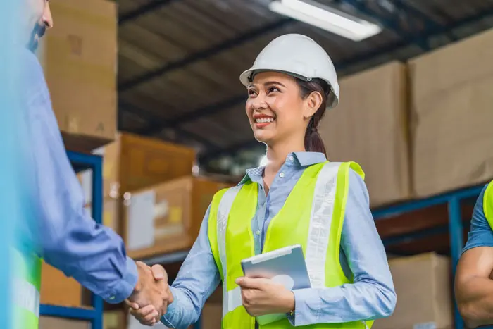 a happy young female shaking hands someone